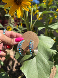 Sterling silver feather hoop post earrings with turquoise.