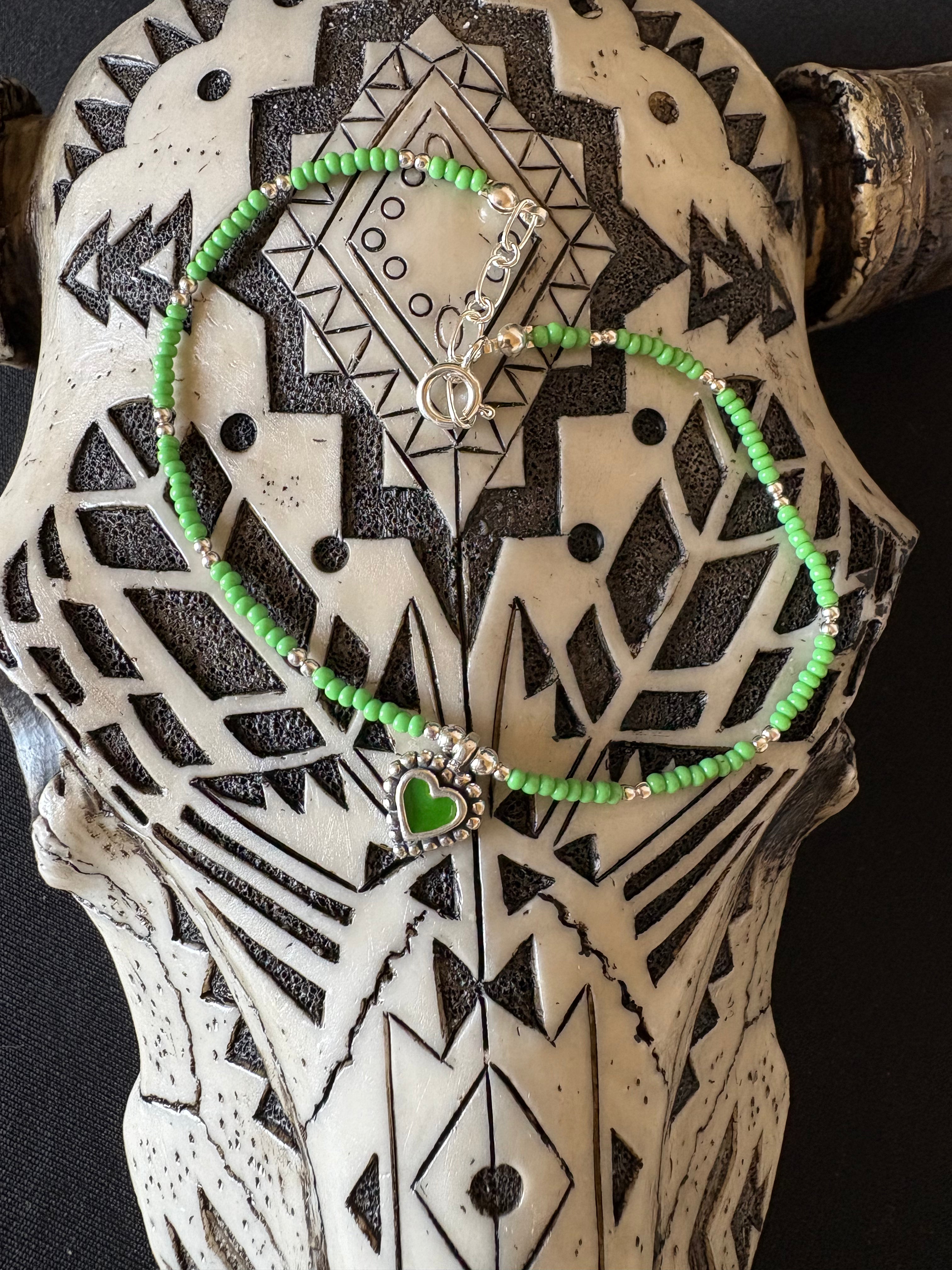 Liquid silver 9” anklet with green beads and heat charm.