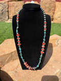 Chimney Butte round 8mm pearls mixed with 4mm saucer pearls. Mix of red spiny and turquoise beads. 25”
