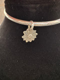 Navijo handmade Sterling silver bangle bracelet 7” with sunflower charm. Artist: Christina Yazzie